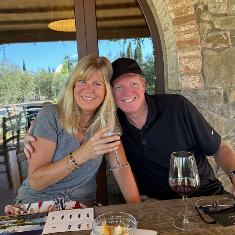 Picture of a couple in Italy drinking wine.