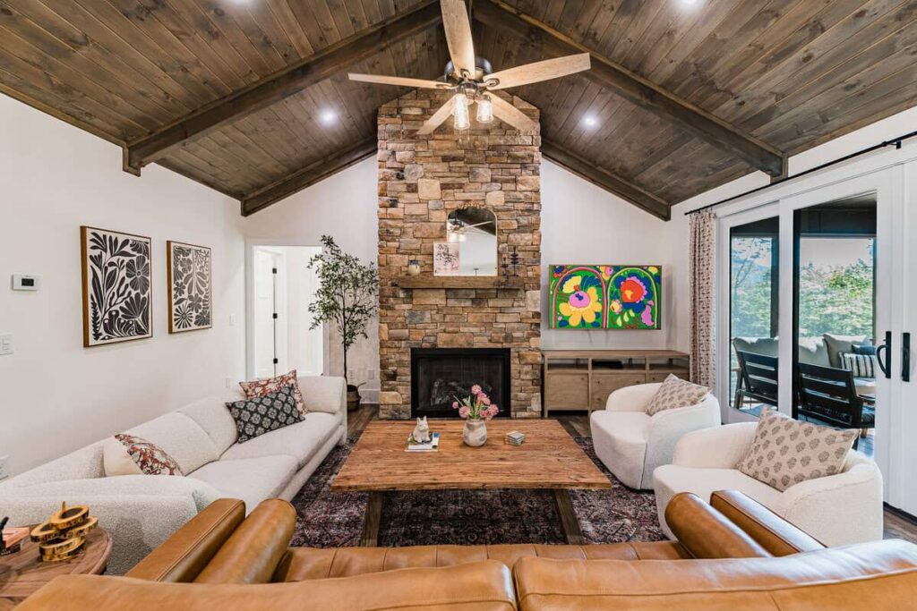 Great room with floor to ceiling fireplace, samsung art tv, and lots of couches and chairs.